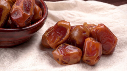 Dates in wooden bowl on background. dried dates fruit.
