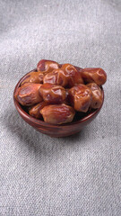 Dates in wooden bowl on background. dried dates fruit.