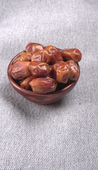 Dates in wooden bowl on background. dried dates fruit.