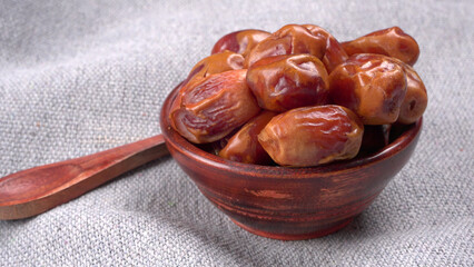 Dates in wooden bowl on background. dried dates fruit.