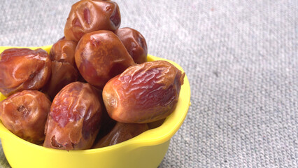 Dates in wooden bowl on background. dried dates fruit.