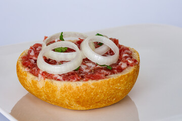 A bun with fresh minced pork meat