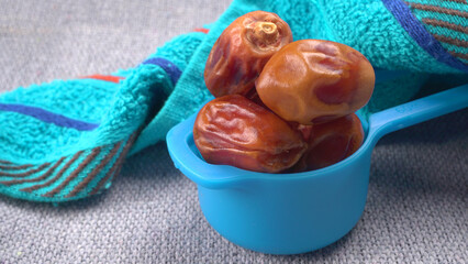 Dates in wooden bowl on background. dried dates fruit.
