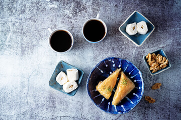 Turkish delight. Baklava and coconut lukum with cups of coffee