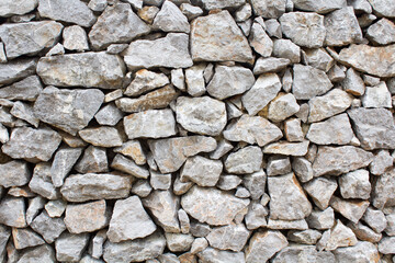 Stone wall with old gray stones
