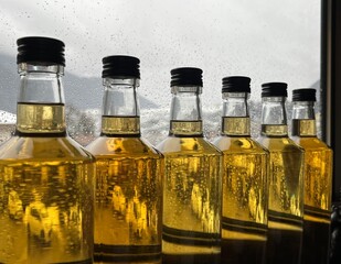 Row of bottles. Yellow liquid