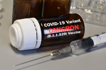 Syringe with hypothetical Covid-19 vaccine against the OMICRON new variant. Fight against virus...