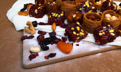 Traditional multi-colored arabic sweets baklava, lokum, muska pestili and nuts assortment. Top view.