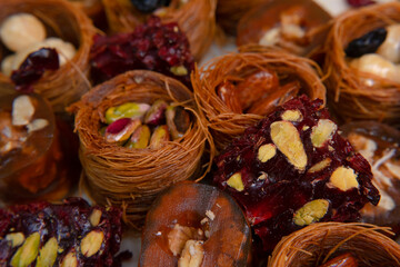 Traditional multi-colored arabic sweets baklava, lokum, muska pestili and nuts assortment. Top view.