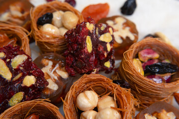 Traditional multi-colored arabic sweets baklava, lokum, muska pestili and nuts assortment. Top view.