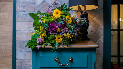 photo of a bouquet of flowers on a pedestal in the interior
