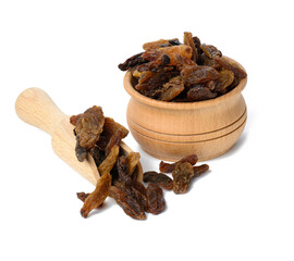 dried brown raisins in wooden bowl and spoon isolated on white background