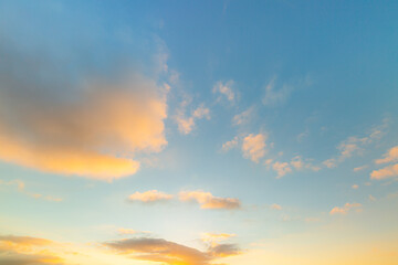 clouds and yellow sky,Sky background at sunset,Sky blue and orange light of the sun through the clouds in the sky