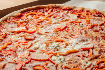 pizza with pepper. big pepperoni pizza. tasty pizza with melting cheese tomatoes ham paprika. Food recipe background. Close up