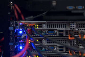 network server room closeup on fiber optic hub or switch for digital communications and internet in mainframe corporate business data center supercomputer. 