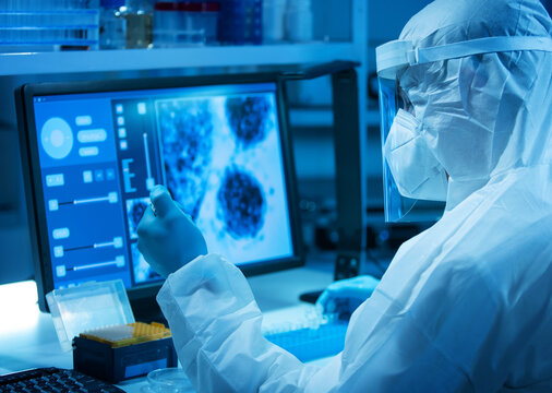 Scientist works in a modern scientific lab using laboratory equipment, microscope and computer technology. Invention of new vaccines. Concept of Science and Health. - Powered by Adobe