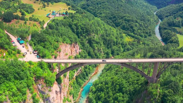 Around on the Djurdjevic Bridge in Montenegro is a concrete arch bridge across the Tara River. Aerial drone view.
