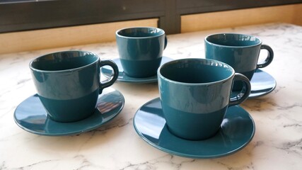 Obraz na płótnie Canvas a set of tea mugs with a sea-green saucer, a set of dishes for tea and coffee