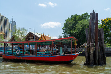 Fototapeta na wymiar Ferry boat moored near Wat Thong Thammachat Pier on the Chao Phraya River. - Bangkok, Thailand.