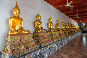 Golden buddha's at the Phra Rabiang Cloister at buddhist temple Wat Pho, Bangkok, Thailand.