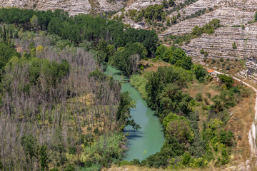 Fototapeta na wymiar View of the Jucar river passing near the town Alcala del Jucar in Spain