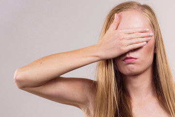 Fototapeta premium Woman covering her eyes with hand
