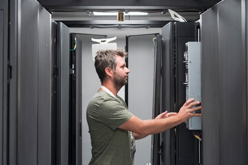 IT engineer working In the server room or data center The technician puts in a rack a new server of corporate business mainframe supercomputer or cryptocurrency mining farm. 