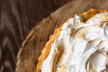 Lemon pie on top of log and wooden table. zenithal view