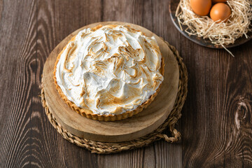 Lemon pie on top of log and wooden table. zenithal view