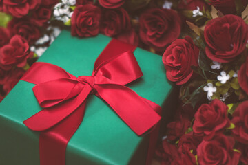 Romantic still life, Red roses with present on a wooden background. Fragrant red flowers, gift concept for Valentine's Day, Wedding or Birthday. Soft focus. any day to say I love you.