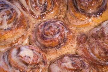Fototapeta premium Delicious cinnamon roll buns with cheese glaze