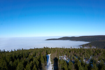 top view landscape black forest in winter with fog and sunshine from the hohlohturm, kaltenbronn