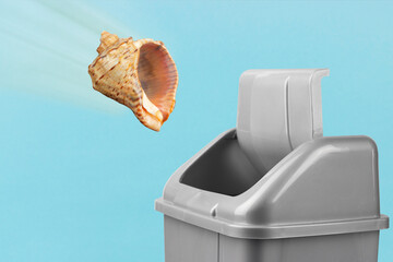 seashell flies into trash can, bad vacation concept, forget about vacation