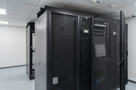 Data Center With Multiple Rows of Fully Operational Server Racks. Modern Telecommunications, Cloud Computing, Artificial Intelligence, Database, Supercomputer Technology Concept.