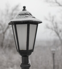 White snow on a lantern in the park.