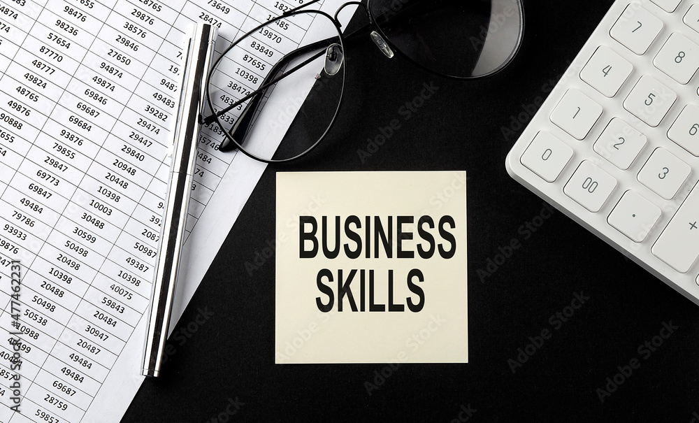 Poster concept business skills message on sticker with glasses,chart and calculator on the black background