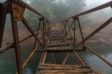 Foto op Plexiglas Broken wooden and metal bridge © Auggie