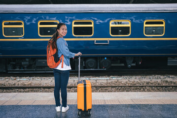 Portrait beautiful woman traveler tourist with bag pack at train station