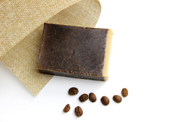 top view of various handcrafted soap with different ingredients in row on white surface.