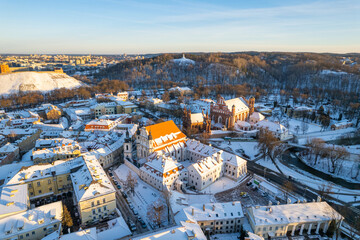 Fototapeta na wymiar Aerial winter sunny frozen day view of snowy Vilnius old town, Lithuania