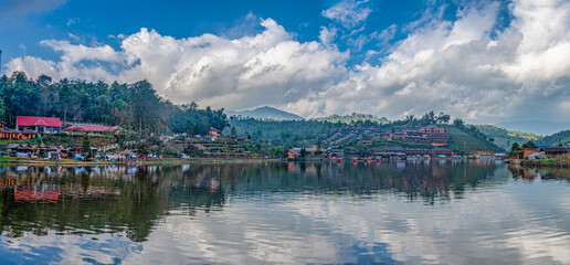 Fototapeta premium Boats in foreground and sunset over the hills in Ban Rak Thai