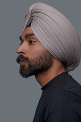 Thoughtful handsome Indian man in the turban looking away