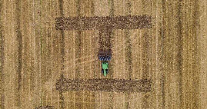 Tractor makes an inscription in the field. Plow