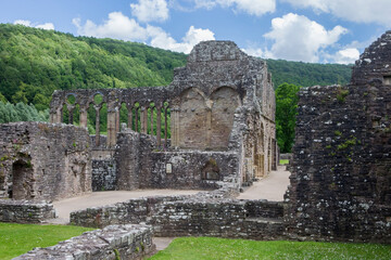 Fototapeta na wymiar Image of the remains and ruins of the famous Tintern Abbey in Monmouthshire, Wales. Landscape image with farm fields.
