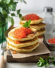Pancakes with red caviarPancakes with red caviar served on a wooden board. A classic dish for the Maslenitsa holiday