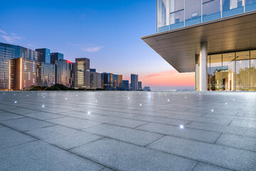 Panoramic skyline and modern commercial office buildings with empty square floors at night