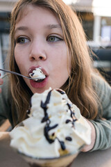 beautiful young girl enjoying a cup of ice cream