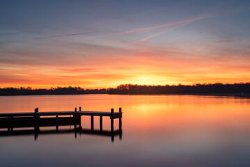Cold and colorful dawn at a lake on a winters morning.