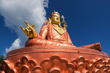 Samdruptse statue , a huge buddhist memorial statue in Sikkim, blue cloudy sky in background. It is...