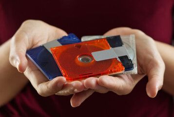 mini disc for data and music record with white background, Colorful mini disks - beautiful retro disks, mini md disk in hand woman with background red color.